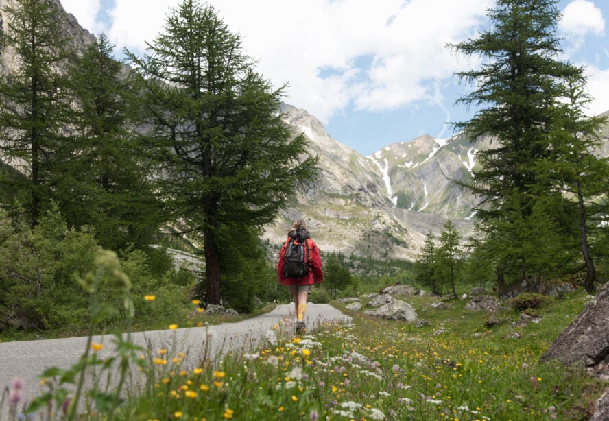 A woman hiker in Val Ferret, an essential part of every Tour du Mont Blanc itinerary