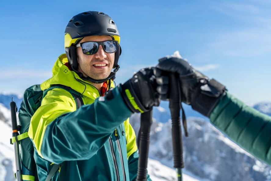 Skiers doing a fist bump on an alpine slope in Europe