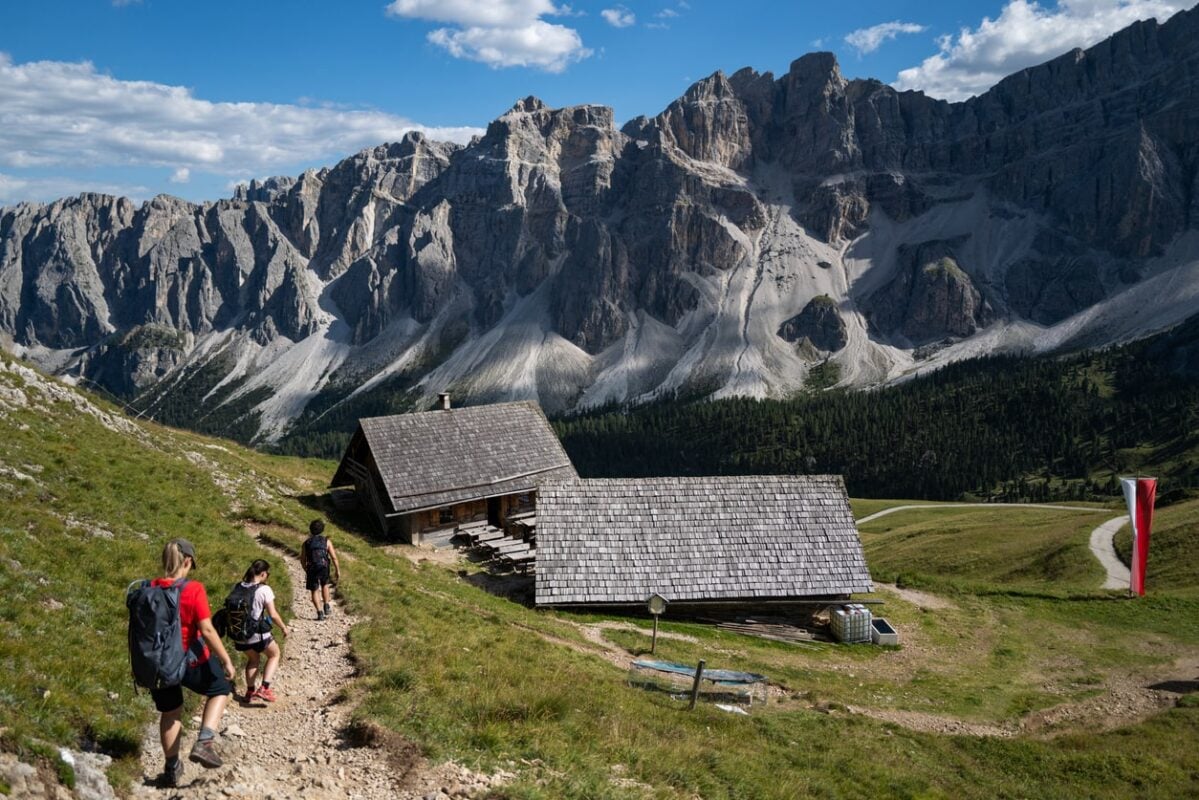 Hikers walking up to a rifugio in the Italian Dolomites.
