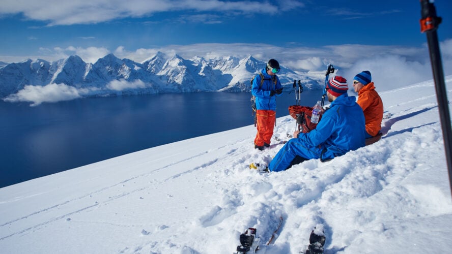 Ski touring lunch by the Lyngen fjord, Norway.