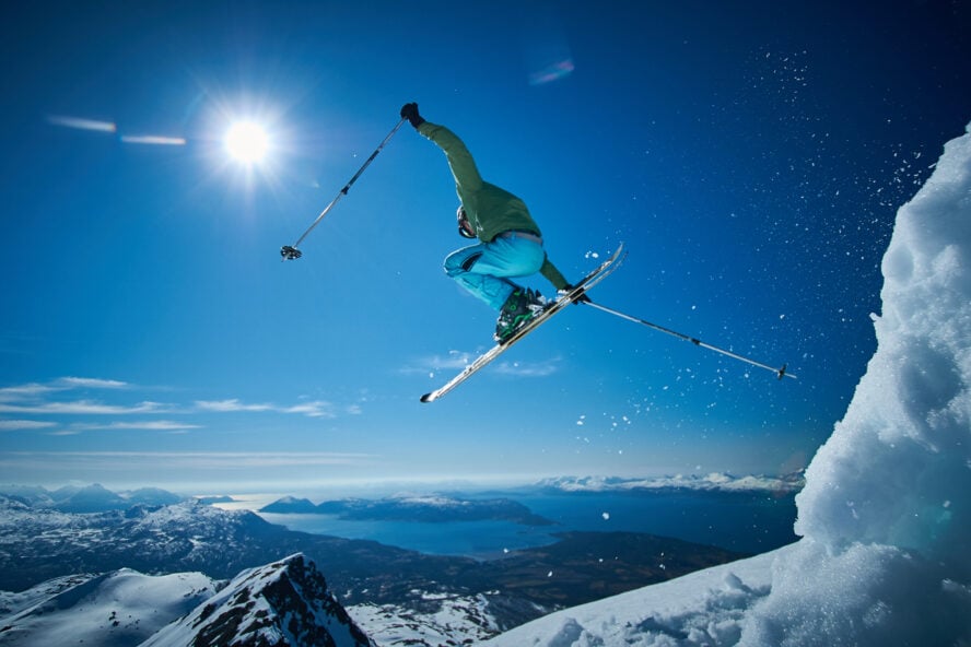What is backcountry skiing - skier jumping in a fjord landscape in Norway