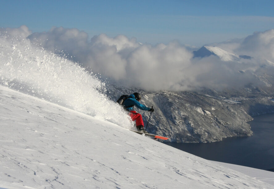 Backcountry skier shredding powder in Sunmore, Norway