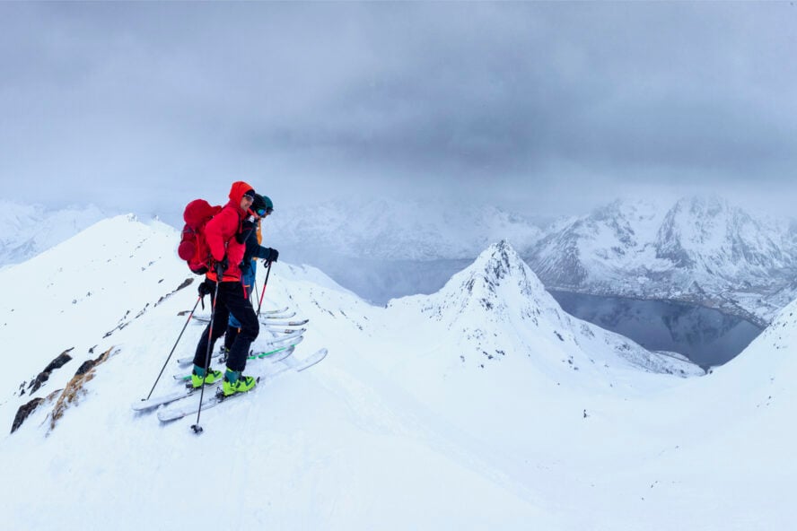 Skiers on a summit in Lofoten, Norway