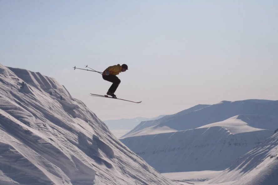 Skier doing a jump in Svalbard, Norway