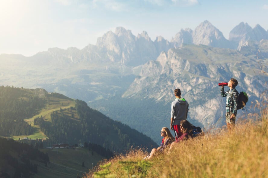 A group of teenage friends, together enjoys adventures on the mountain along the Alta Via 2, on the Italian Dolomites.
