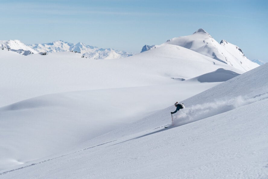 A backcountry skier skiing down a slope in Georgia