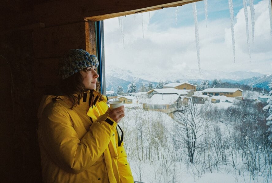 A woman drinking tea at a ski resort in Georgia