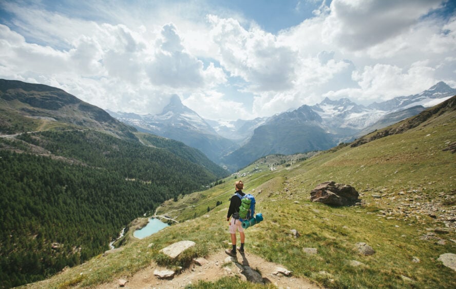 Hiker looking at Matterhorn mountain in the distance along the Walker's Haute Route