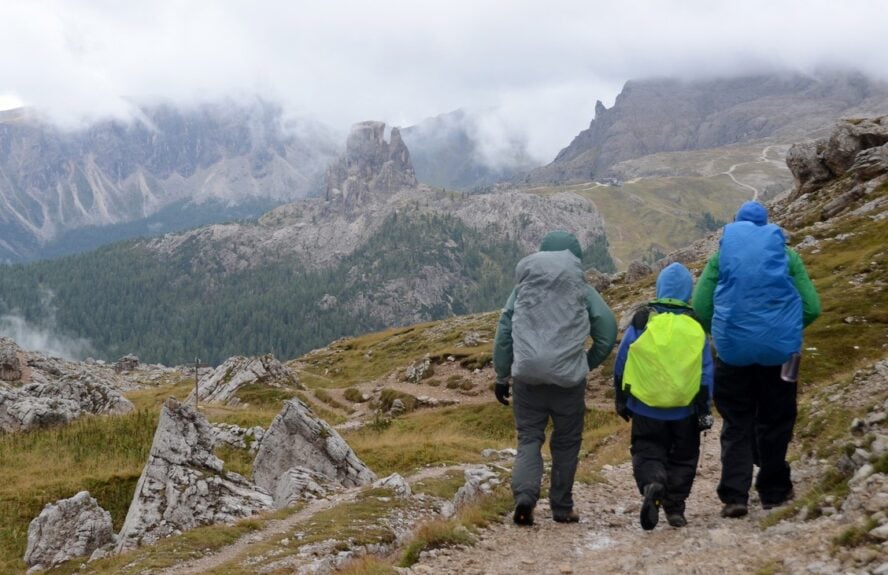 Hikers along an Alta Via route with packed backpacks