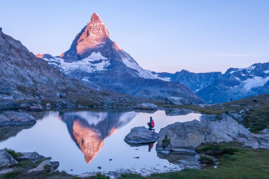 A hiker admiring a vista of the Matterhorn along the Walker's Haute Route