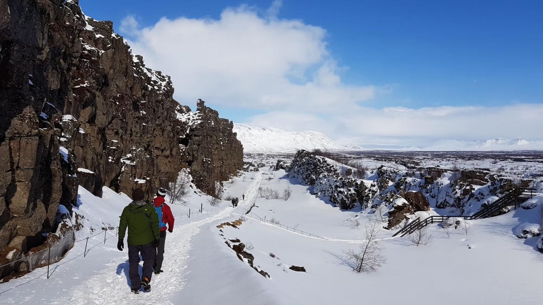 Several people walking Iceland