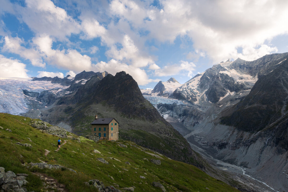 A log cabin surrounded by glaciers in the Swiss Alps
