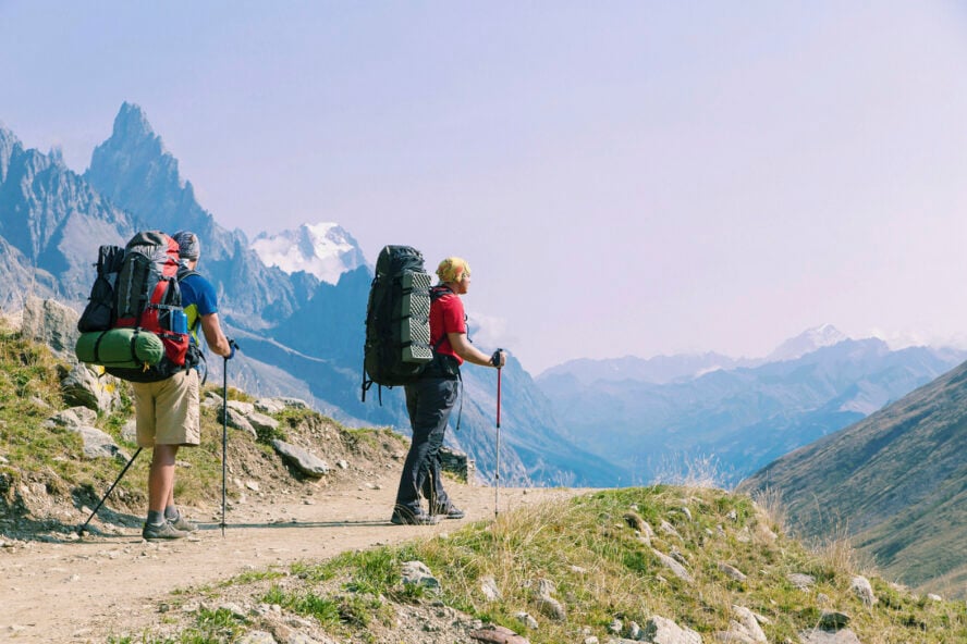 Two hikers wearing backpacks along the Tour du Mont Blanc