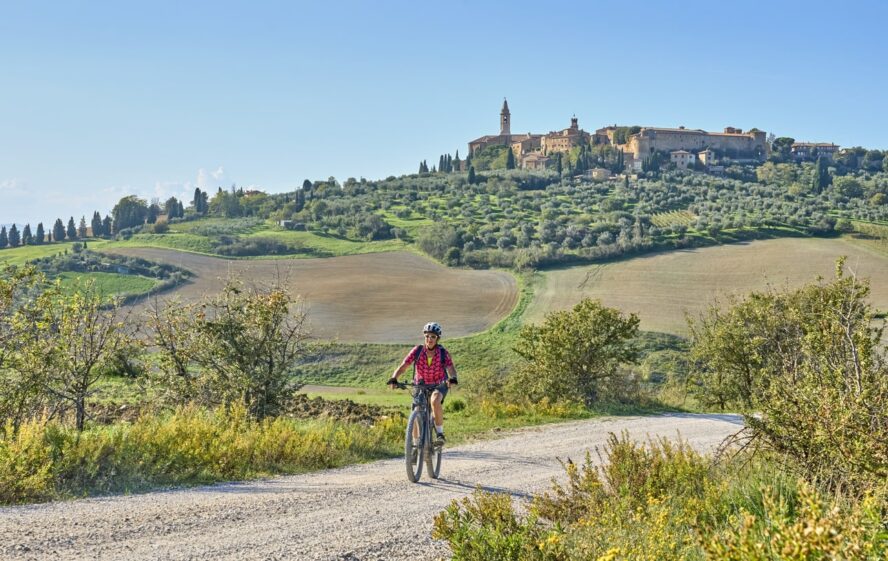 An e-bike rider and a castle on a self-guided tour of Tsuscany, Italy
