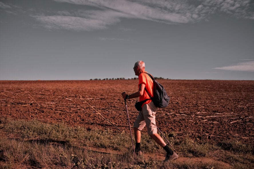 Older hiker hiking in nature along the Camino