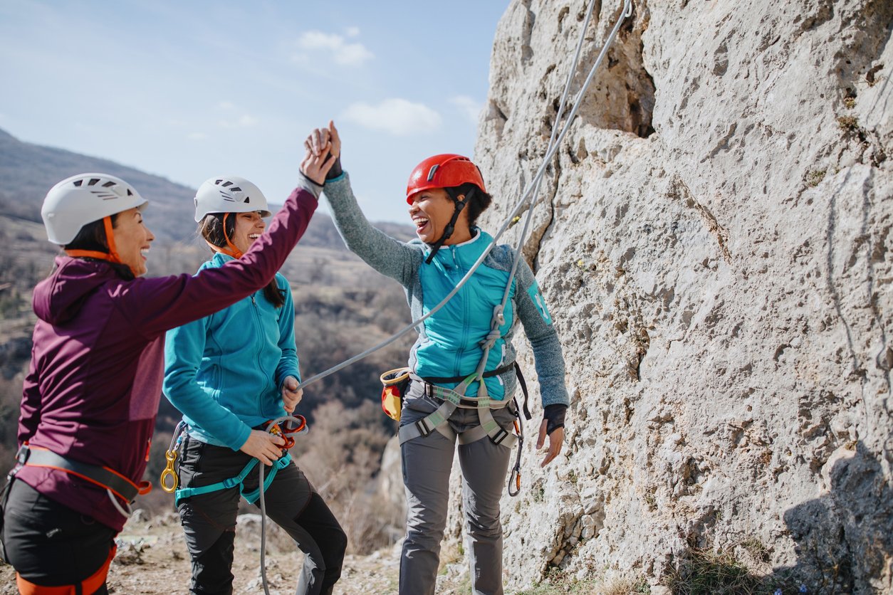 Climbers giving high fives after successfully finishing climb