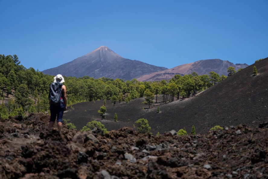 A hiker doing the Chinyero volcanic walk in Tenerife, Spain
