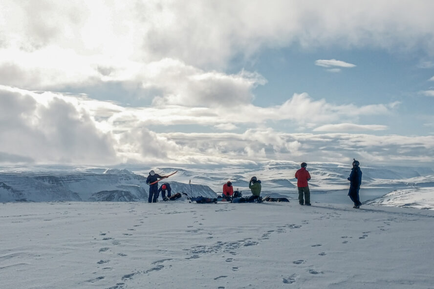 Skiers checking their ski gear in Iceland on a sunny day