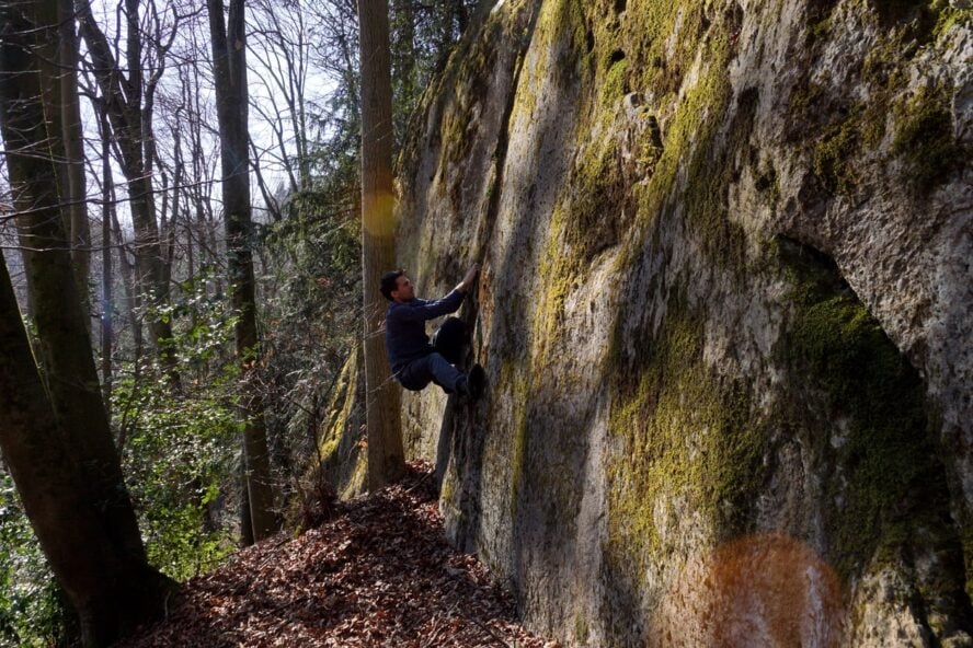 A man boulder climbing in Frankenjura, Germany