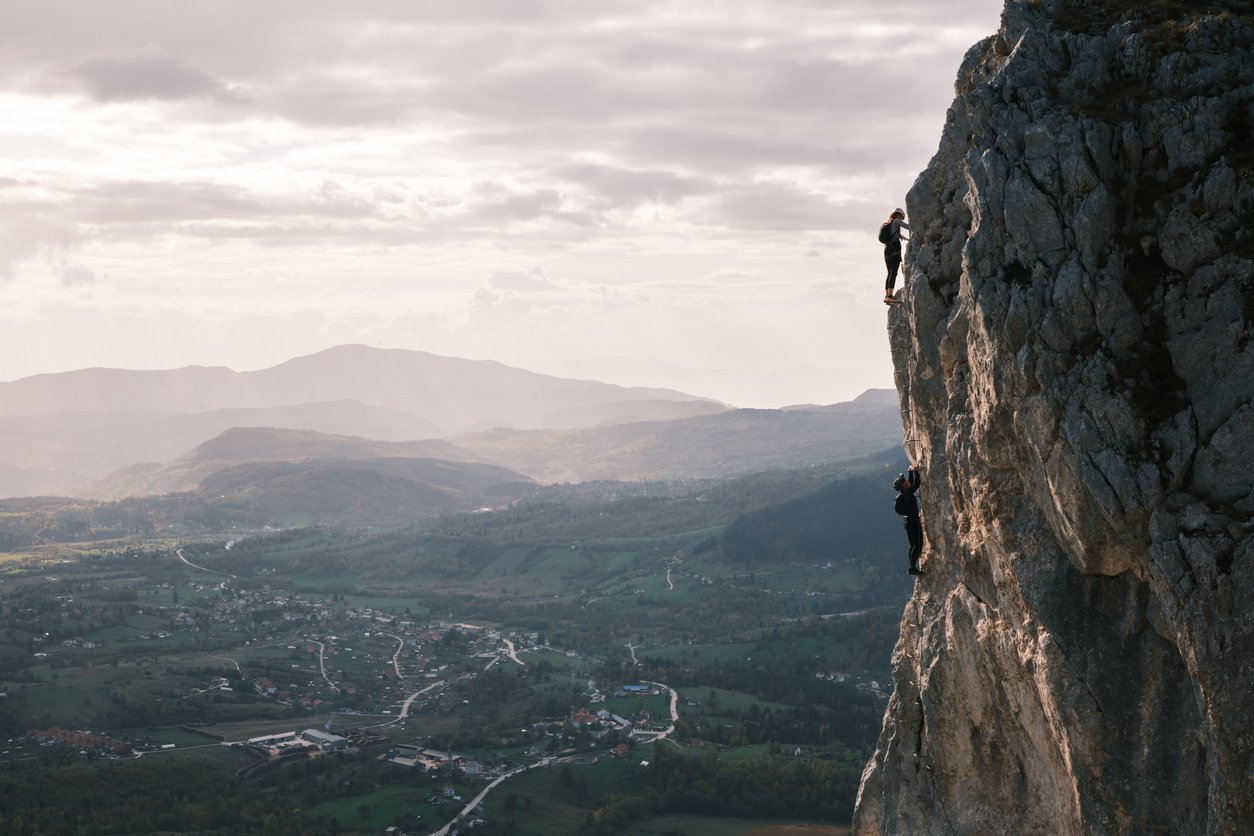 Rock Climbers in front of a beautiful vista on a rock climbing trip in Europe