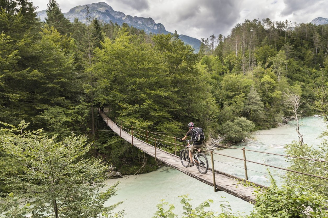 A rider on a bike crossing a bridge in Slovenia