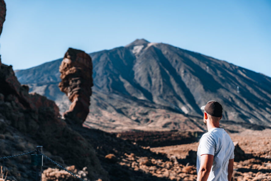 Man looking at the Finger of God and Teide volcano in Tenerife