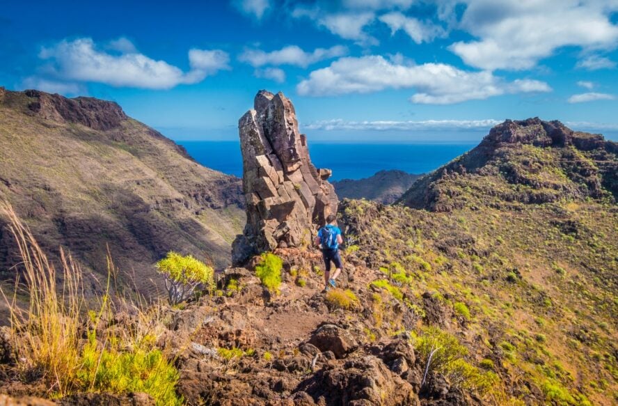 A Tenerife hiker hiking in volcanic terrain