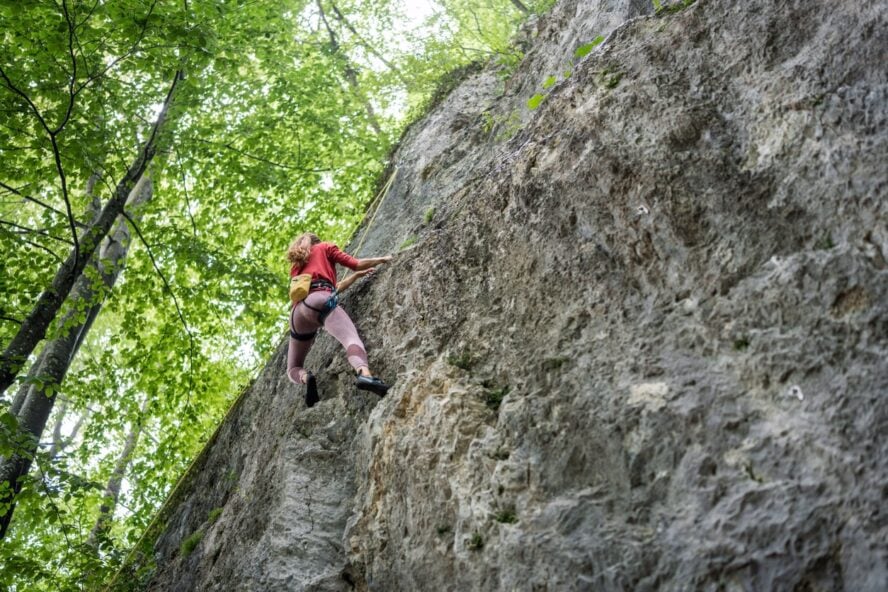 A woman climbing a route in Frankenjura, Germany