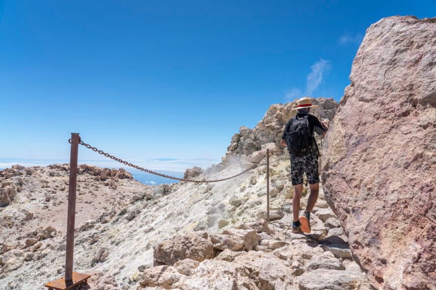 A young man hiking on top of Mount Teide, Tenerife, Spain