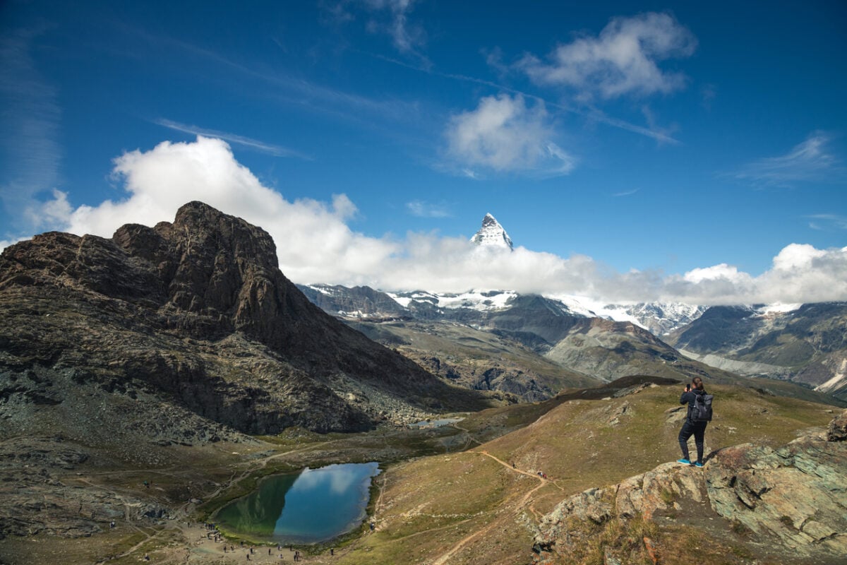 Hiker Overlooking Riffelsee and the Matterhorn on a Summer Day - Zermatt, Switzerland