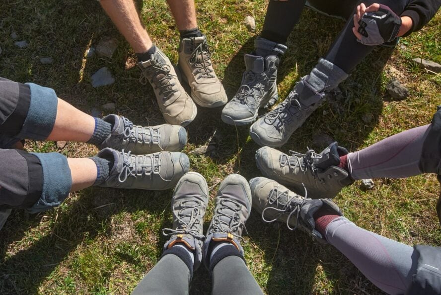 Hikers showcasing different designs of hiking boots