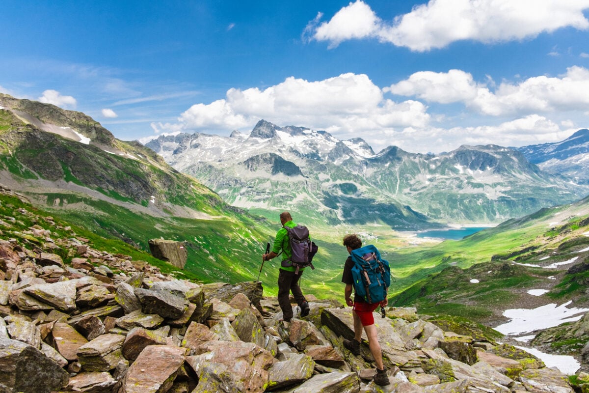 Hikers exploring a mossy valley in Graubunden, Switzerland