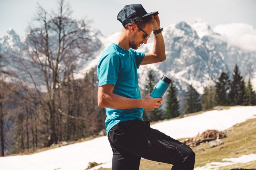 Man in a blue hiking shirt on a mountain trail in the USA.