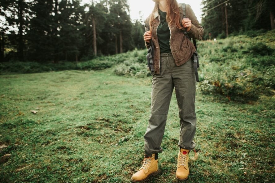 Woman wearing hiking pants on a green meadow in Iceland