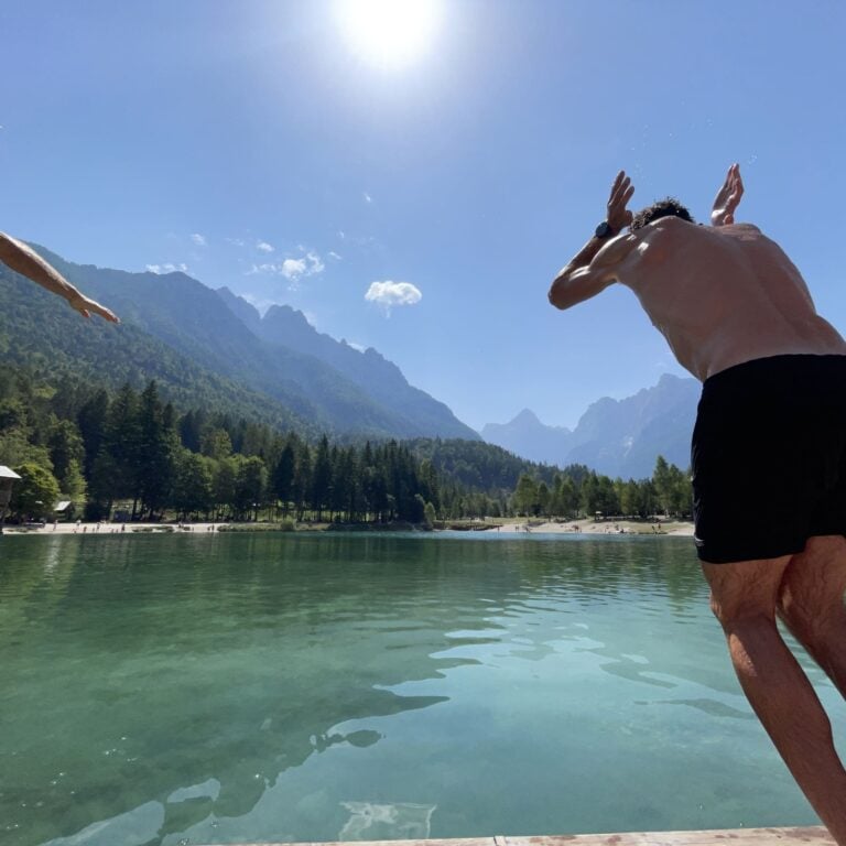 jumping in the lake in the dolomites