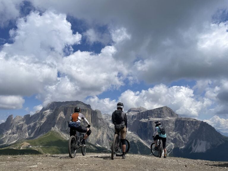 three mountain bikers dolomites