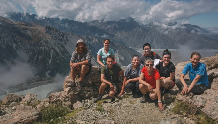 Hikers posing near Mount Cook in New Zealand South Island