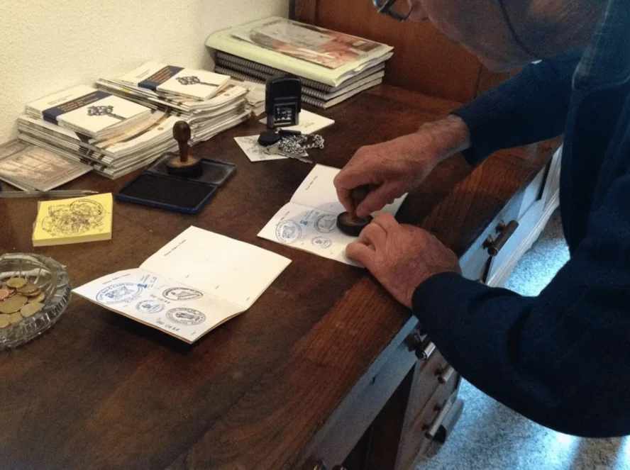 Stamping a pilgrim's passport after completing the Camino