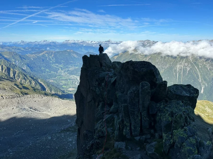 A climbing guide on top of a rock in Chamonix.