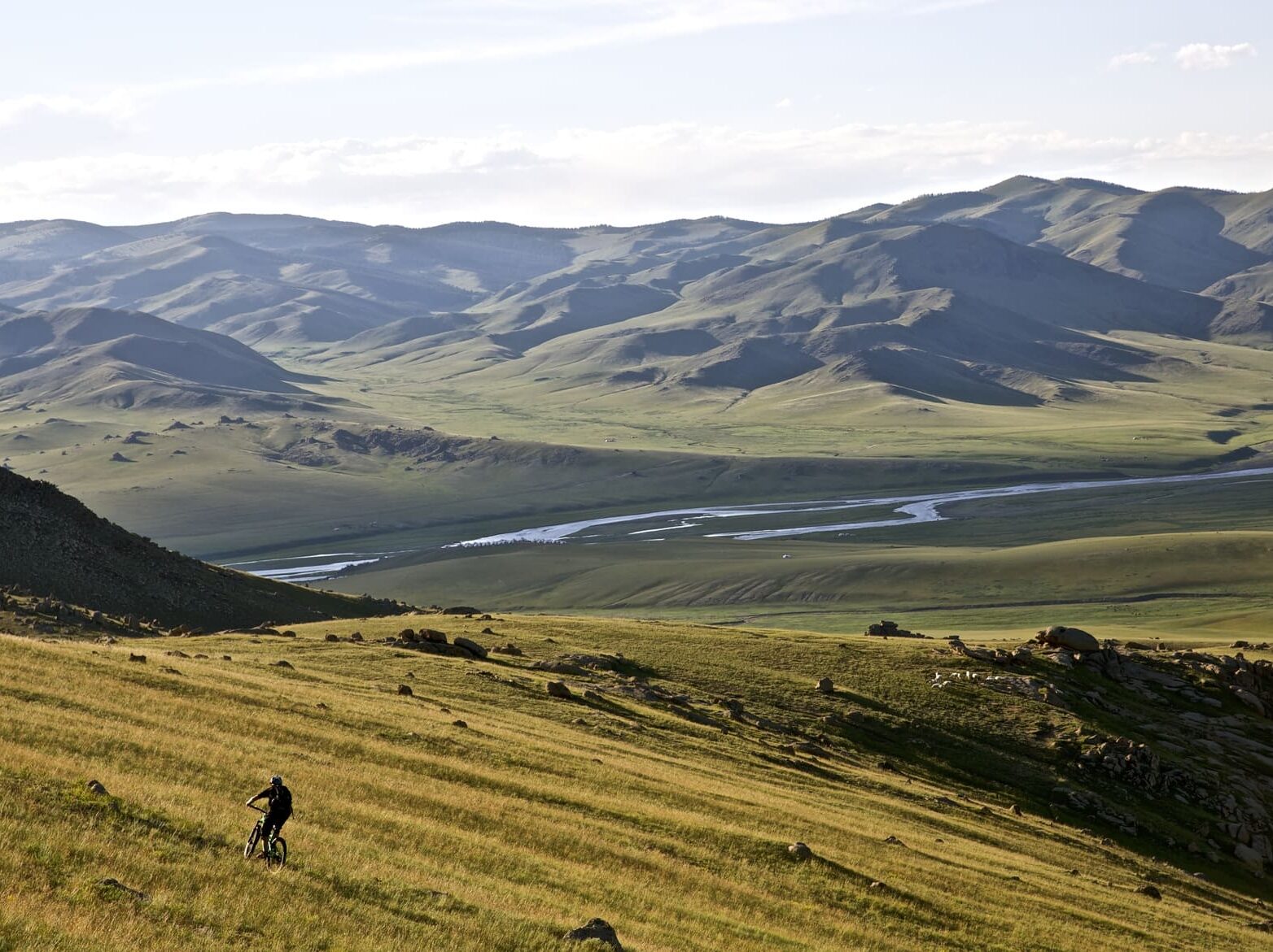 Biker near river in Mongolia