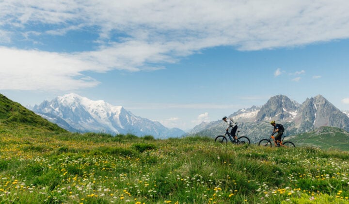 Bikers near a meadow in the Alps