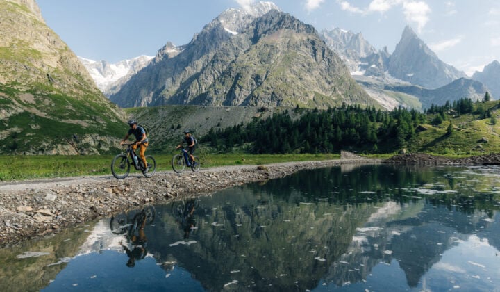 Biking alongside a lake in the Alps