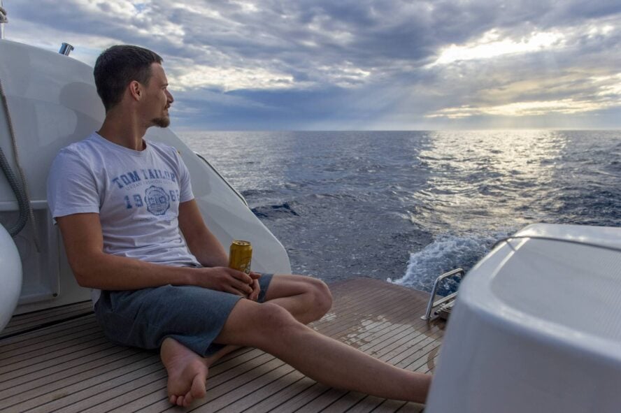 Climber drinking beer on boat