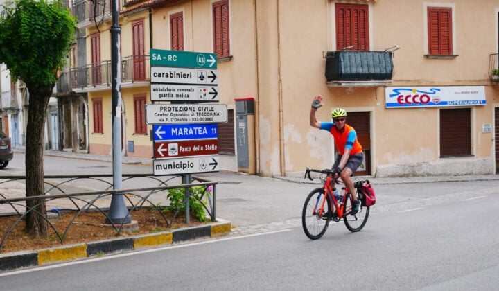 Cyclist and road signs in Italy