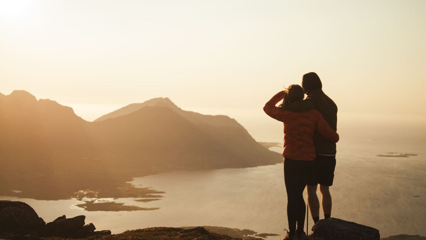Hikers watching the sunset in Lofoten