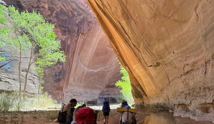 Hikers under arch in Utah