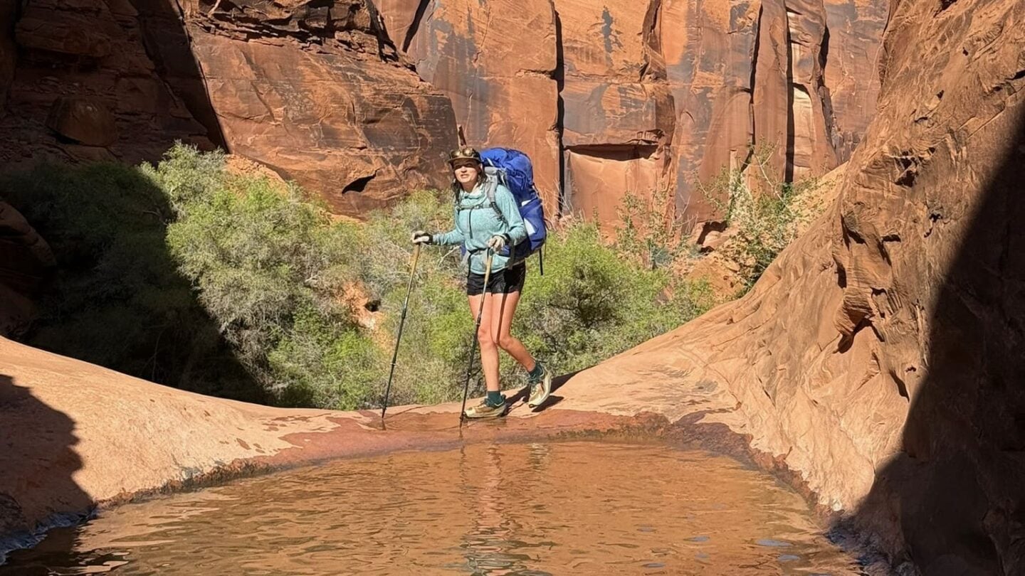 Hiking with poles near water in Utah