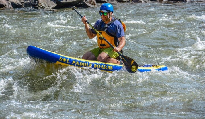 Sitting paddleboarding in Colorado