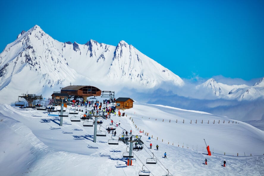 Ski station on top of the high mountain in Les Arcs region of Alps with chairlifts and snow peaks on background