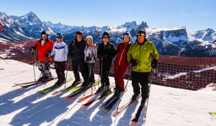 Skiers posing in the Dolomites